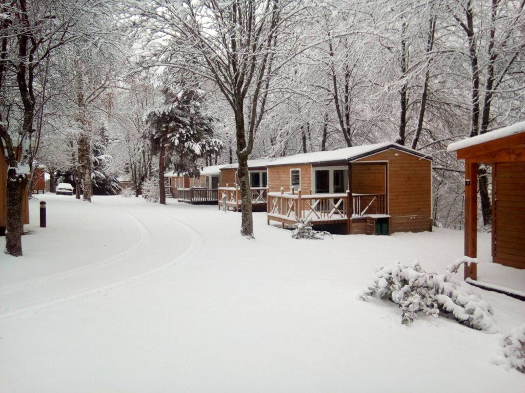 The campsite huts under a heavy blanket of snow with snow-covered trees