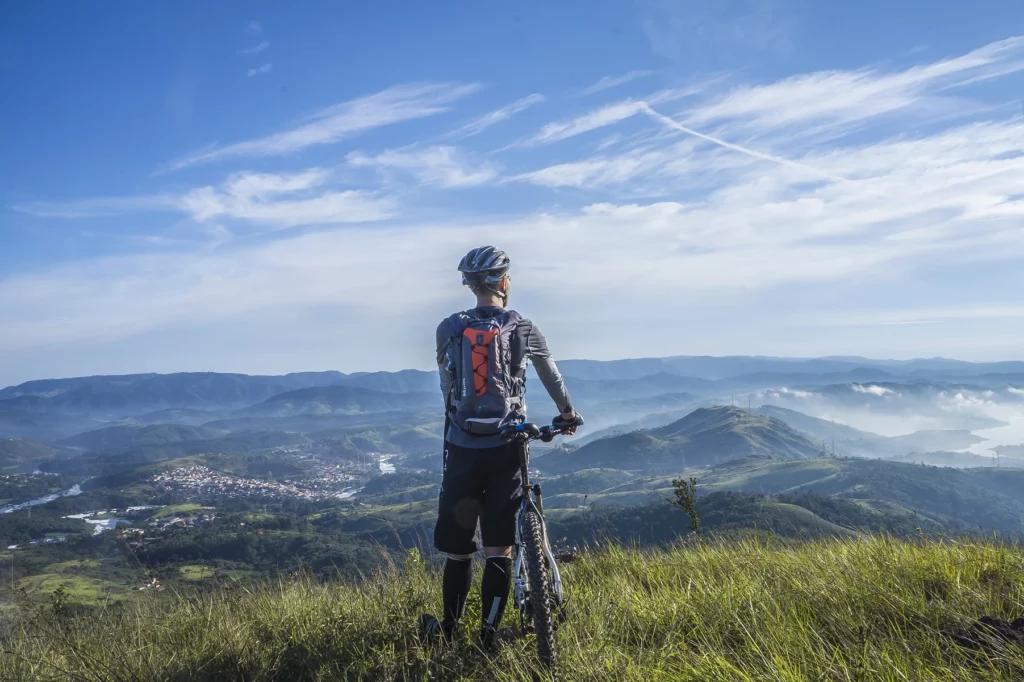 Ciclismo de montaña en la cima de la montaña mirando al cielo