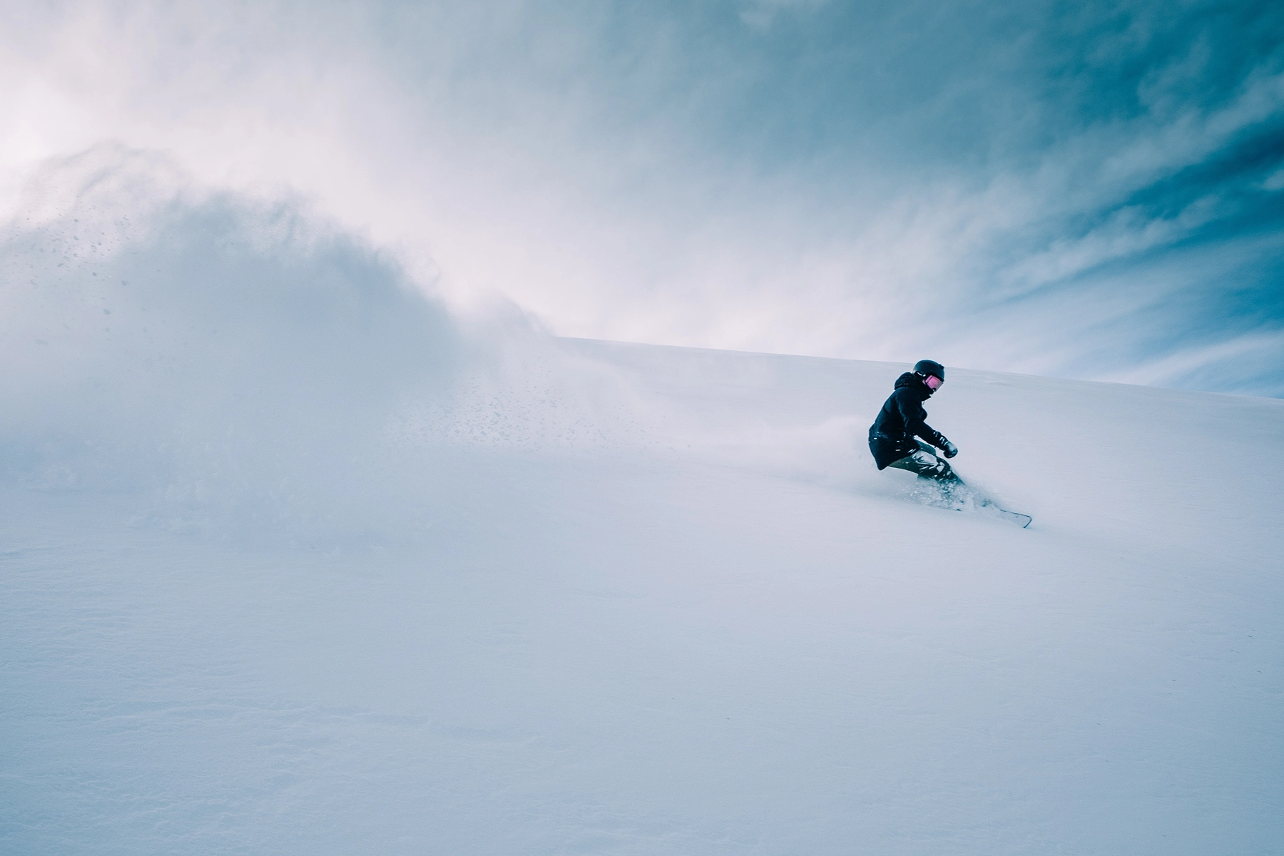 Downhill snowboard ski slope in the powder near the chalets of the lake in the Pyrenees