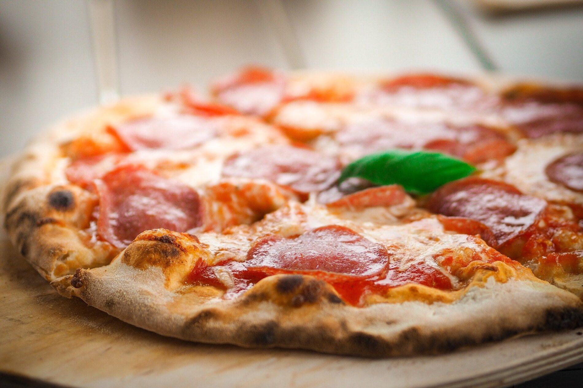 Pizza Peperoni with a basil leaf